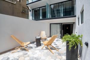 twee stoelen en een tafel op een patio bij HOTEL LUCA in Mexico-Stad