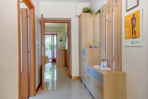 a hallway with wooden cabinets and a dresser in a room at Apartments with a parking space Mali Losinj (Losinj) - 8024 in Mali Lošinj