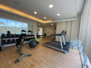 a gym with treadmills and exercise equipment in a room at ENTIRE 2BR CONDO UNIT@8 SPATIAL CONDOMINIUM in Davao City