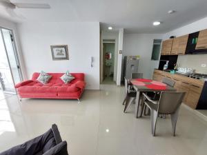 sala de estar con sofá rojo y mesa en Apartamento Aqualina Orange Piso Octavo Vista a Piscina, en Girardot