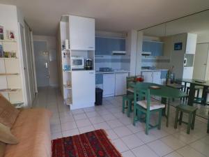 kuchnia i jadalnia ze stołem i krzesłami w obiekcie Appartement 4 pers. avec terrasse et piscine, plage à proximité - FR-1-472A-259 w mieście Sète