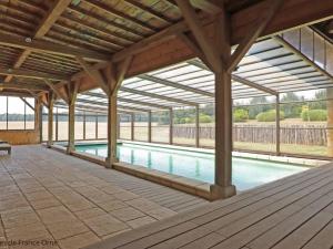 a swimming pool under a wooden pavilion with a swimming pool at Gîte Rémalard, 6 pièces, 14 personnes - FR-1-497-164 in Rémalard
