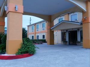 a large building with an arch in front of it at Americas Best Value Inn and Suites Bush International Airport in Humble