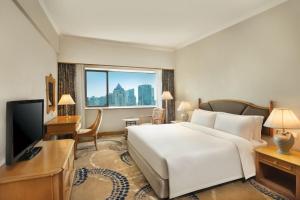 a hotel room with a large bed and a television at Crowne Plaza Chengdu City Center by IHG in Chengdu +124 photos