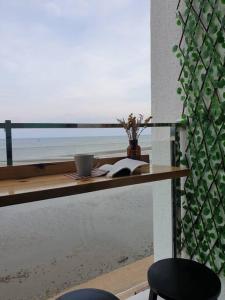 a table with a book and a cup and a book at Best Moments studio balcony- Imperium Resident in Kuantan