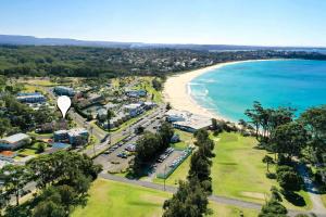 an aerial view of a beach with a hot air balloon at Surfmist Four on Mollymook in Mollymook