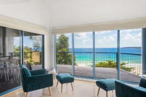 a living room with a view of the ocean at Northstar on Mollymook Beach in Mollymook