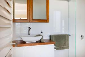a bathroom with a sink and a mirror at Northstar on Mollymook Beach in Mollymook
