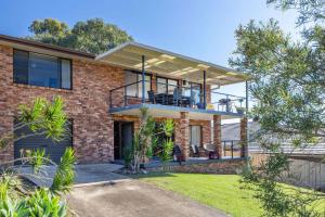 an image of a house with a balcony at Narrawallee Retreat in Narrawallee
