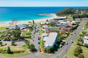 an aerial view of a town with the beach at Breakers 5 in Mollymook