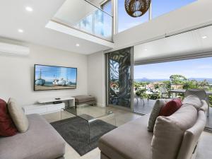 a living room with a couch and a glass table at Unit 3 Taralla 18 Edgar Bennett Avenue Noosa Heads in Noosa Heads