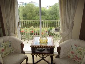 a living room with a table and chairs and a large window at Killyon Guest House in Navan