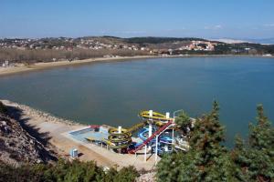 a water park with a roller coaster on a beach at Apartments with a parking space Lopar, Rab - 14089 in Lopar