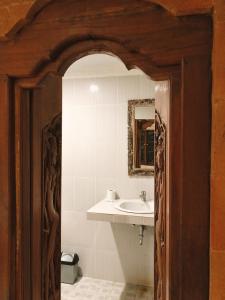 a bathroom with a sink and a mirror at Darma Yogi House in Ubud