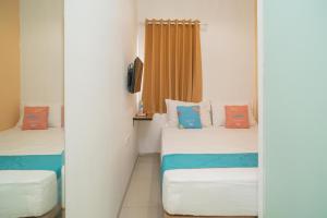 Katil atau katil-katil dalam bilik di Sans Hotel Kupang Indah Surabaya by RedDoorz