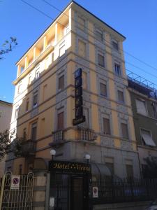 a building with a sign on the side of it at Hotel Vienna in Milan