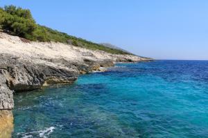 a body of water next to a rocky shore w obiekcie Secluded fisherman's cottage Cove Ripisce, Dugi otok - 394 w mieście Brbinj