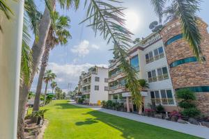 a view of the front of a building with palm trees at Jeju Nine Resort in Jeju