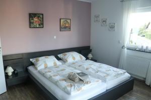 a bedroom with a bed with a bag on it at Deine-Eifel-Ferienwohnung in Feusdorf