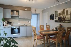 a kitchen and dining room with a table and chairs at Deine-Eifel-Ferienwohnung in Feusdorf