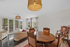 - un salon avec une table et des chaises en bois dans l'établissement Old Fernshaw Cottage, à Healesville