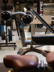 a gym with a chair in a room at Master Hotel Reggio Emilia in Reggio Emilia