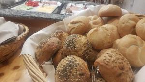 a basket filled with lots of bread on a table at Landgasthof Wangerstuben in Oberostendorf