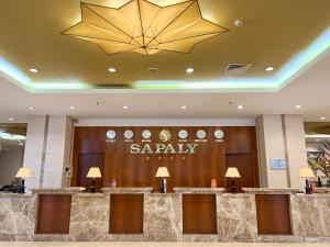 a hotel lobby with a spa sign on the wall at Sapaly Lao Cai City Hotel in Lao Cai