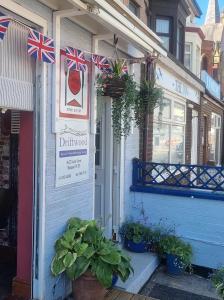 a storefront with british flags on the side of a building at Tracey's Driftwood in Blackpool