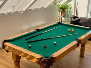 a pool table with balls on it in a living room at Rodinný dom v Lučivnej pod Vysokými Tatrami in Lučivná