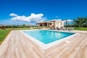 a swimming pool in front of a house at Villa del Nord in Sa Pobla