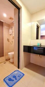 a bathroom with a shower and a sink and a toilet at PP Hotel by Moxy in George Town
