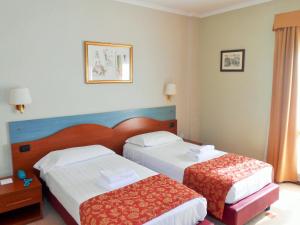 Postel nebo postele na pokoji v ubytování Hotel Riviera Fiumicino