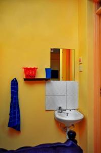 a bathroom with a sink and a mirror at Attic Place South B in Nairobi