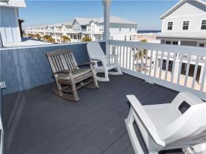 a deck with two chairs and a bench on a house at Sea View Play home in Navarre