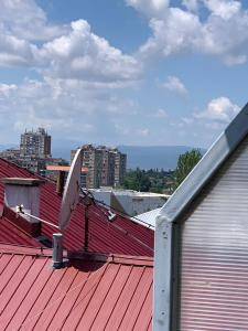 a roof with a satellite dish on top of it at Comfy Studio - 1 minute walk to Delta Planet in Niš