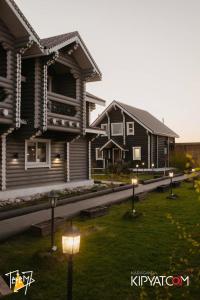 a house with lights in the grass in front of it at Terem Inn in Karagandy