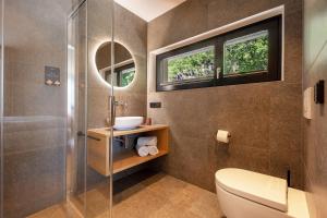a bathroom with a toilet and a shower at Videre Penthouse Lodge exclusive in Gargazzone +36 photos
