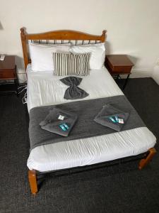 a bed in a room with two pillows on it at Cornwall Hotel in Moonta