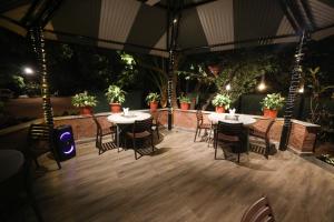a patio with tables and chairs in a tent at Bella Vista Mahabaleshwar in Mahabaleshwar