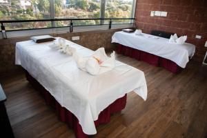 two tables with white napkins on them in a restaurant at Bella Vista Mahabaleshwar in Mahabaleshwar