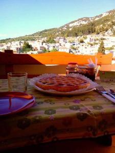 a table with a pizza on top of a table at AFFITTACAMERE DORGALI B&B da ZIETTO in Dorgali