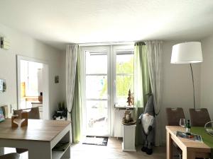 a living room with a large sliding glass door at Waldläufer Brilon in Brilon