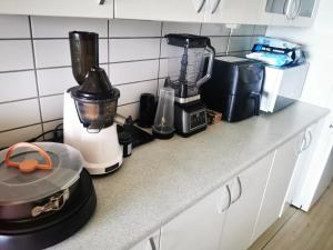 a counter with a blender and other appliances on it at Midt Town Apartment Room in Aarhus