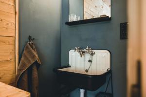 a bathroom with a sink and a toilet in it at Alpenblick Bergrestaurant & Hotel in Arosa