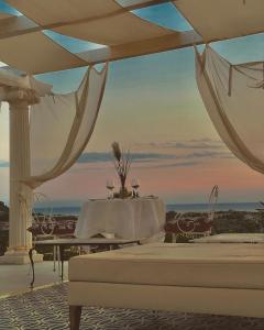 a room with a white table and a view of the ocean at L'incanto di Nausicaa in Ascea