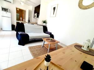 - un salon avec un canapé et une table dans l'établissement 2P 42m² Terrasse / Piscine / Clim / Plage !, à Juan-les-Pins