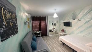 ベナルマデナにあるestudio jupiter vista al marのベッドとソファのある寝室