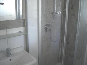 a bathroom with a shower and a sink at Pension Florianhof in Schonach