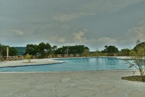 a large swimming pool with a wooden fence around it at Mara Maisha Camp in Talek